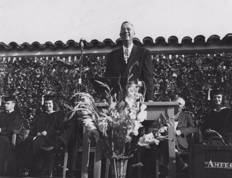 Mt. SAC's first president, Dr. George Bell, at the college's first graduation in 1947, reads a telegram from California Governor Earl Warren: 