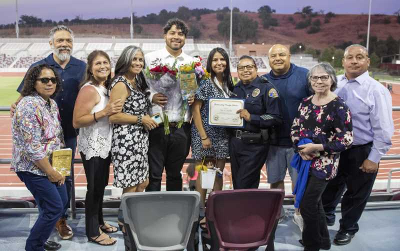 Students, friends and family hold up their 